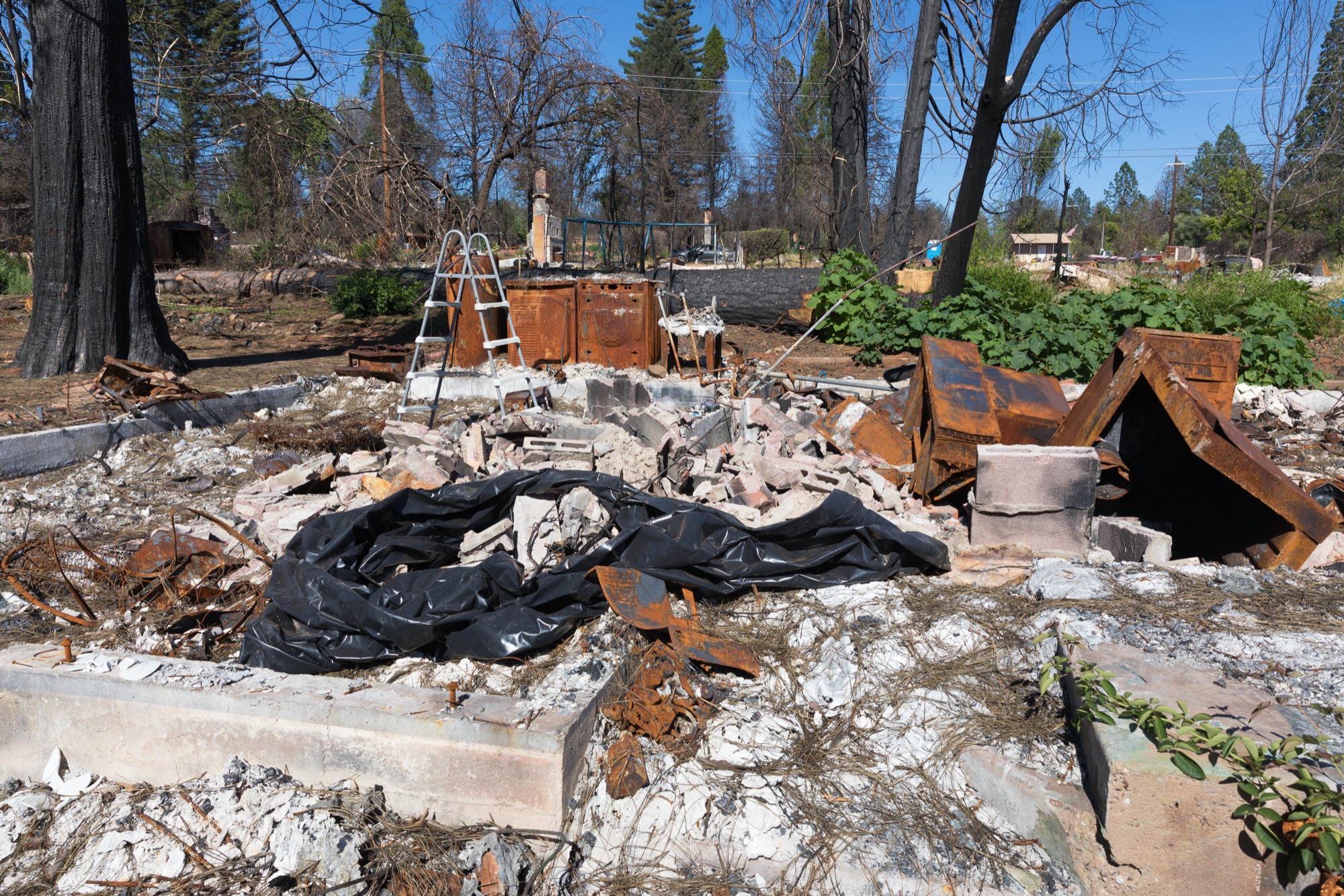 The burned foundation and debris of a home destroyed in the fire
