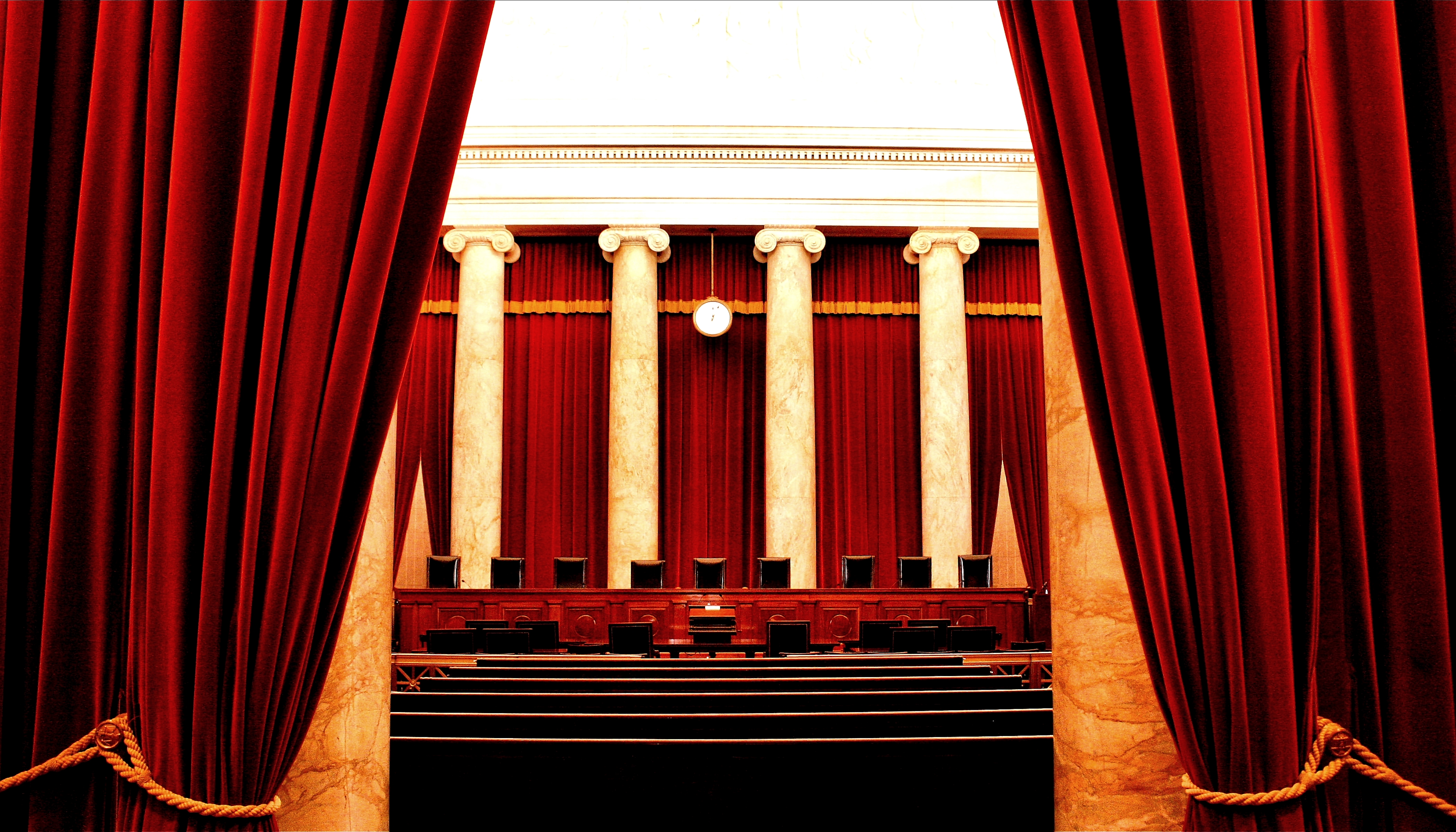 Ionic capitals and pillars behind the courtroom bench